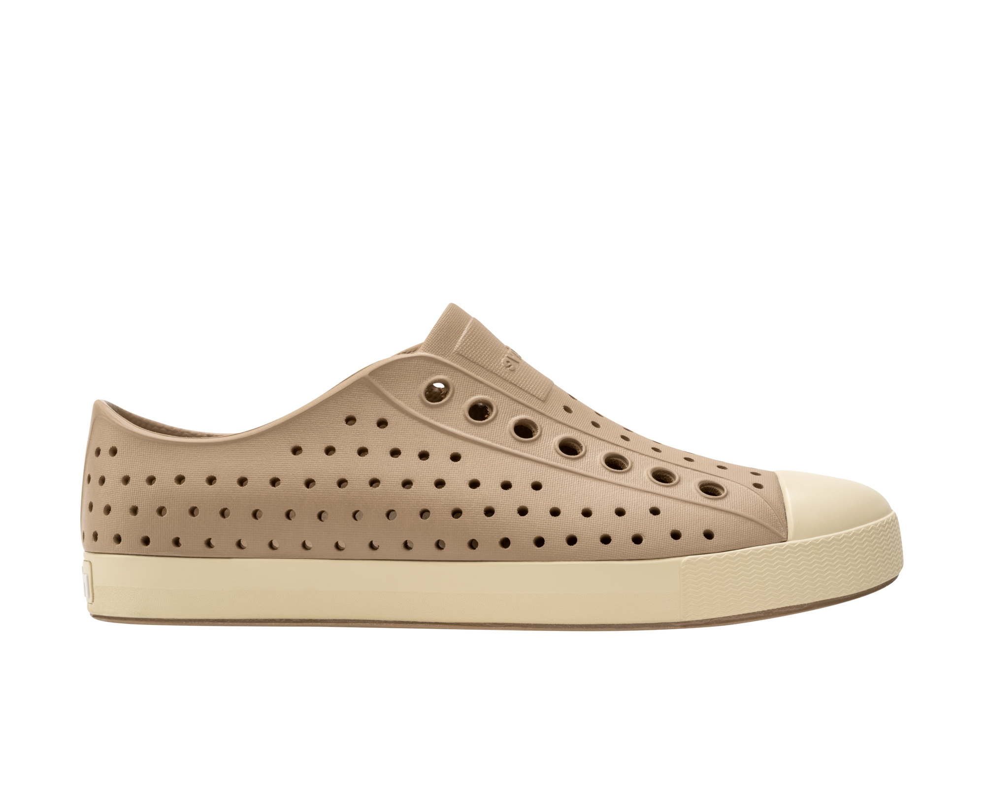Side view of a Native Shoes Adults Jefferson Footwear in Flax Tan / Bone White
