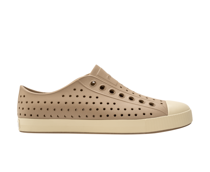 Side view of a Native Shoes Adults Jefferson Footwear in Flax Tan / Bone White