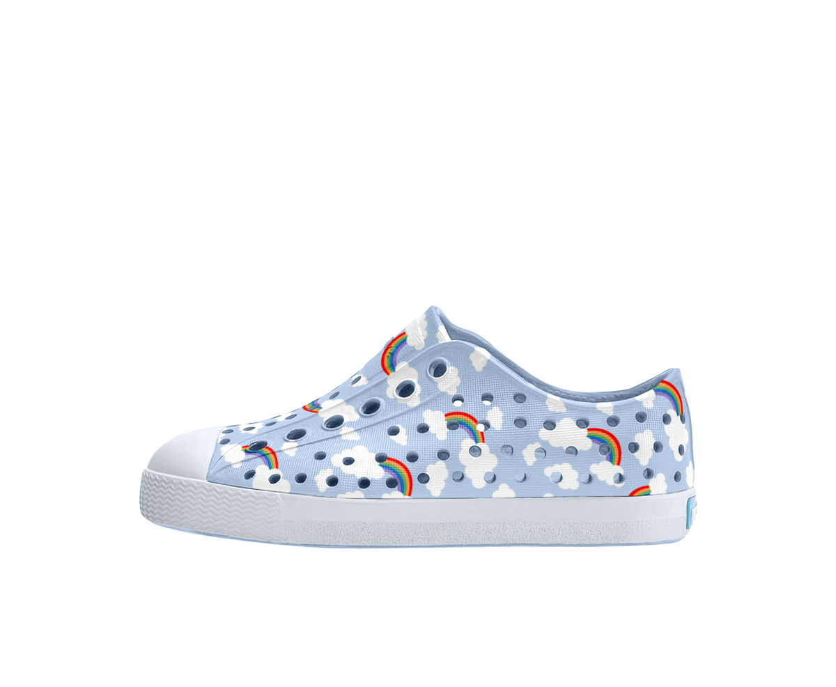 Side view of a Native Shoes Kids Jefferson Print Kids Footwear in Skyway Blue / Shell White / Cloud Rainbow
