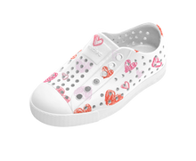 Angled view of a Native Shoes Kids Jefferson Print Kids | Shell White / Shell White / Heart Graffiti Footwear in Shell White / Shell White / Heart Graffiti