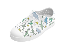 Angled view of a Native Shoes Kids Jefferson Print Kids | Shell White / Shell White / Flux Alpine Dino Footwear in Shell White / Shell White / Flux Alpine Dino