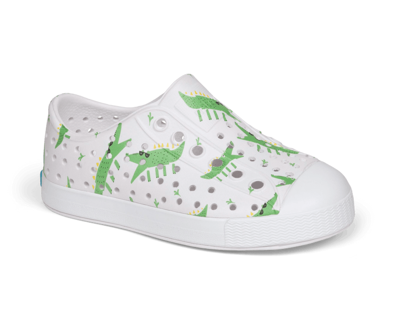 Angled view of a Native Shoes Kids Jefferson Print Kids | Shell White / Shell White / Alligators Footwear in Shell White / Shell White / Alligators