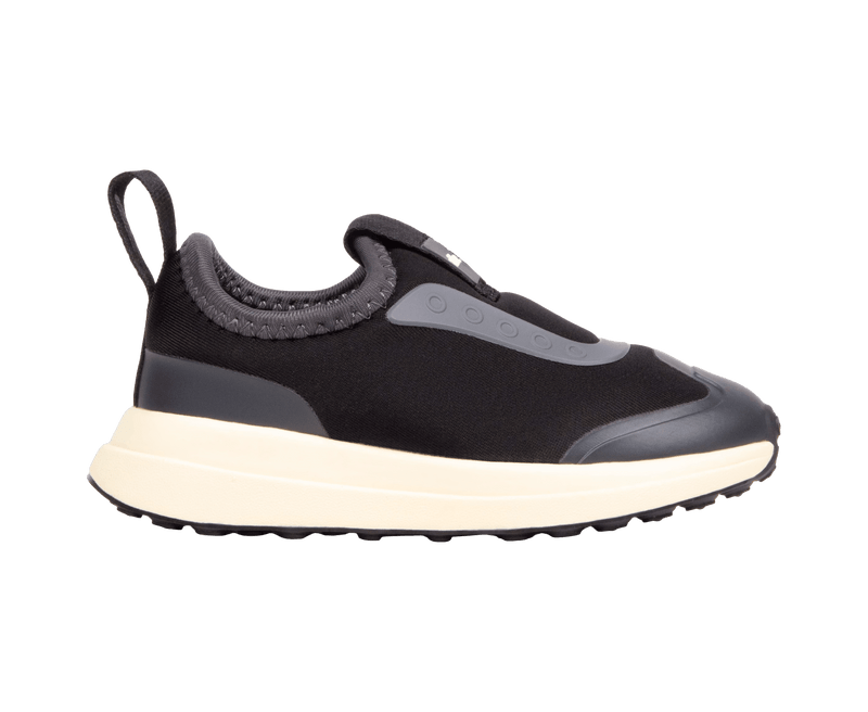 Side view of a Native Shoes Kids Robbie Dash Kids Footwear in Jiffy Black / Tapioca Off White / Jiffy Black